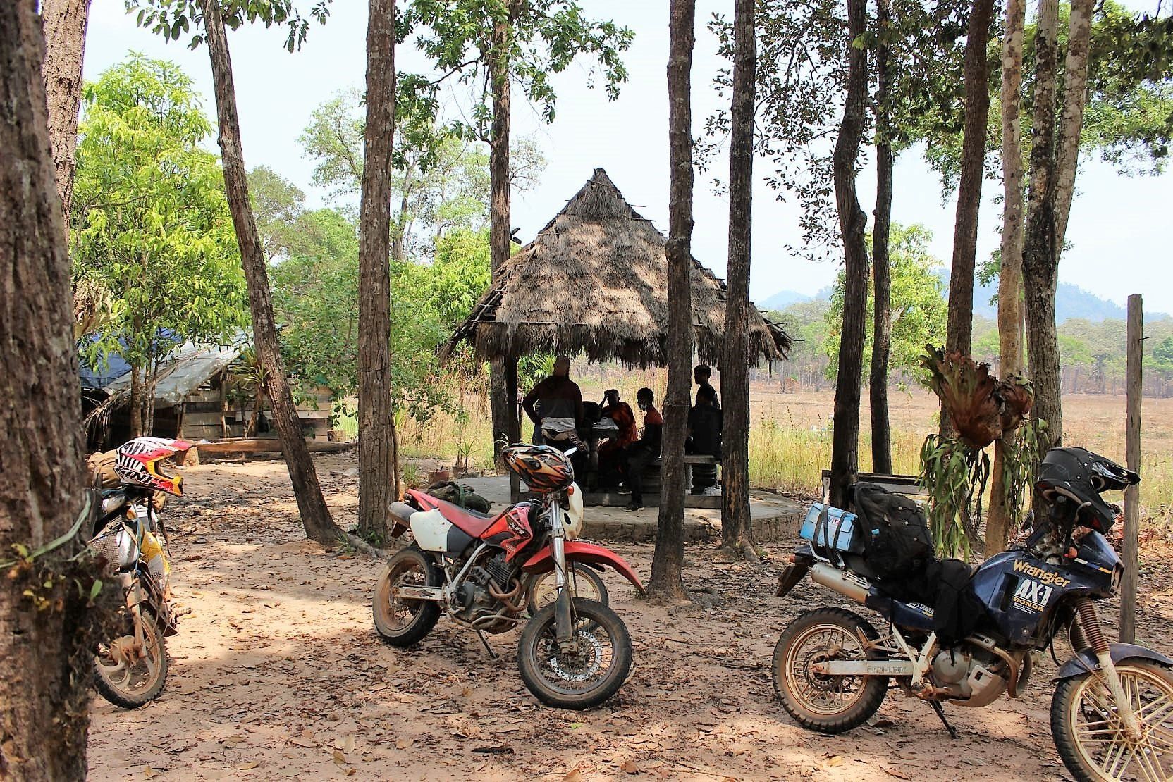 Missionaries on dirt bikes traveling through jungle terrain